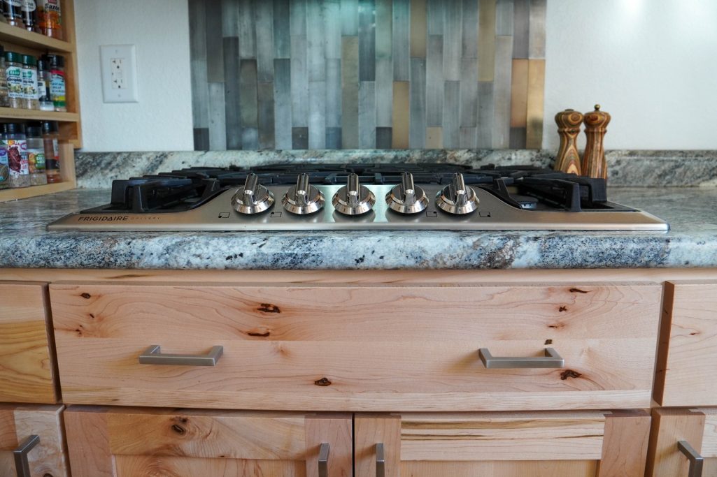 Custom crafted drawer below stove.