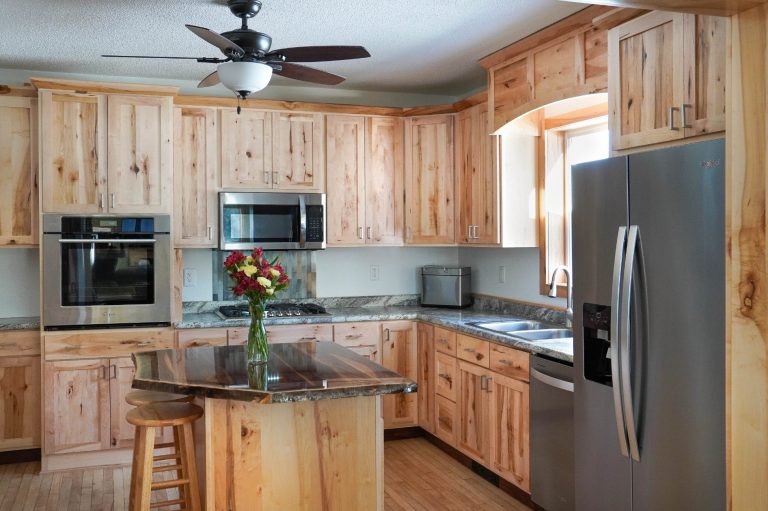 Custom Rustic Maple cabinets with a live-edge wooden slab island.