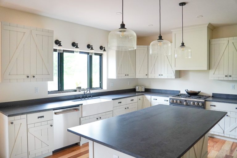 Amish built white painted Maple cabinets with grey countertops.