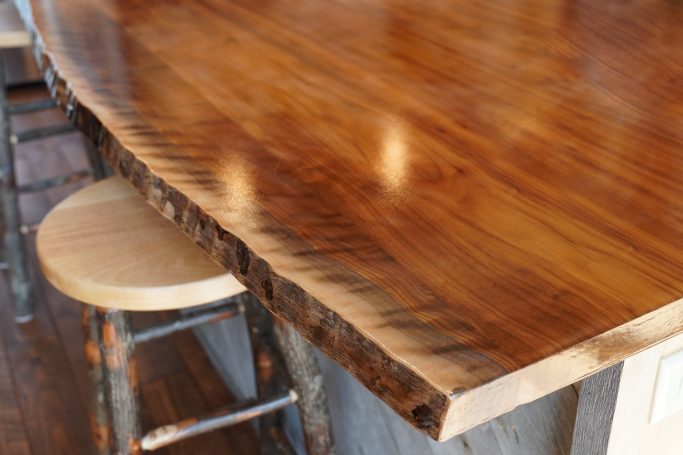 Close up image of live edge on the custom made wood island.