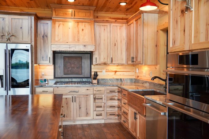 Well lit kitchen with custom features.