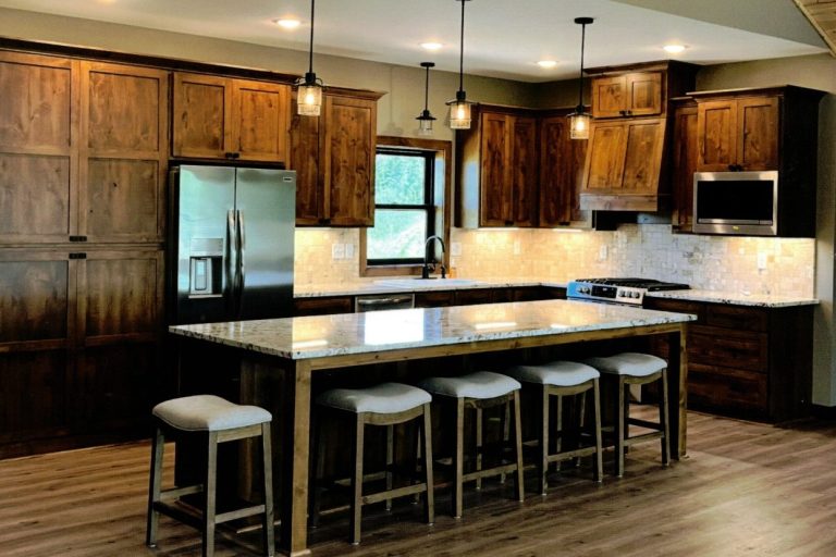 Stained Knotty Alder Cabinets with white marble countertops. 