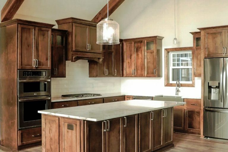 Custom made Birch wood cabinets with white tile backsplash.