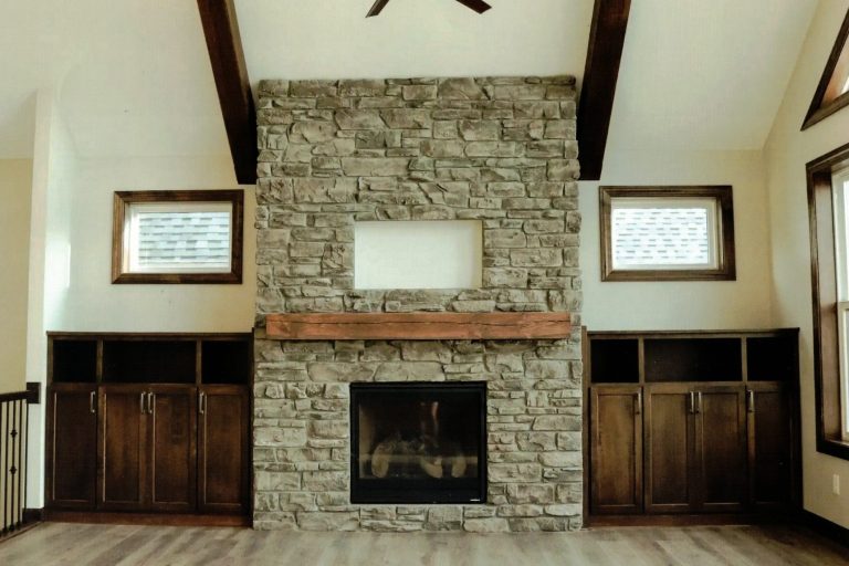 Custom fireplace mantel and living room storage cabinets.