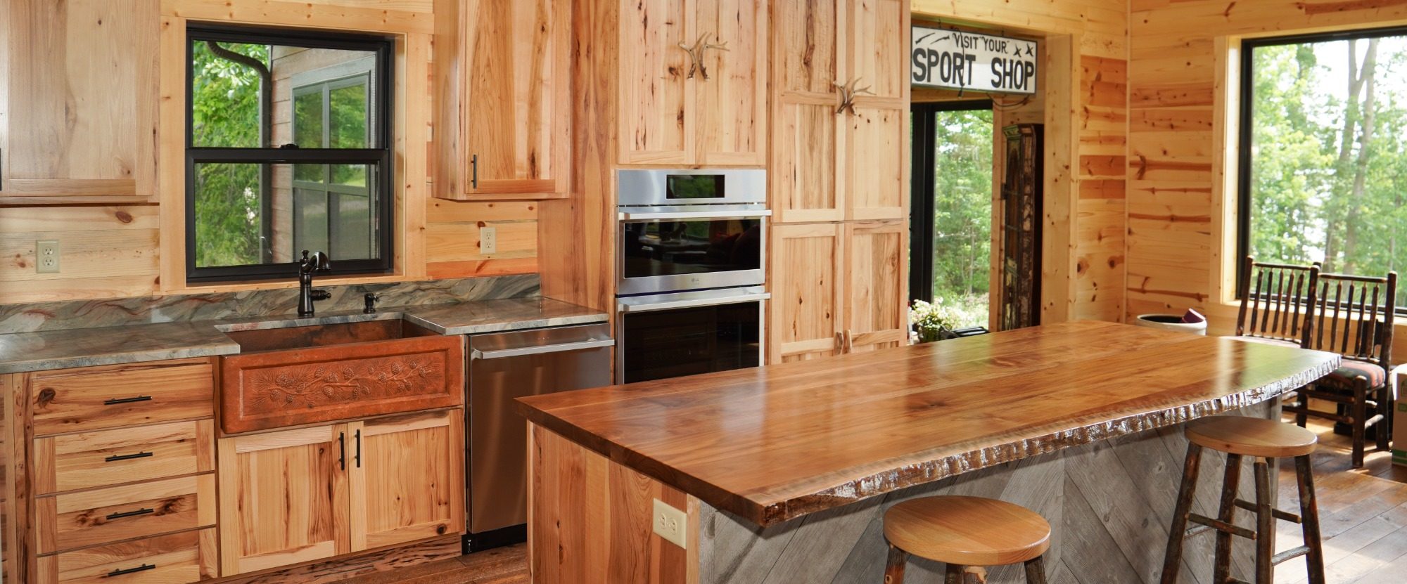 Landscape image of a gorgeous kitchen with custom made hardwood cabinetry work.